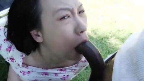 Asian slut gagging on long black cock